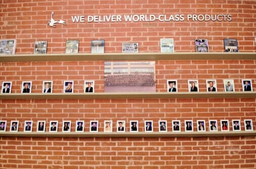 Image of brick wall with polaroid photos of Addison employees