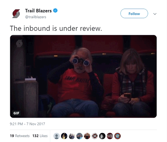 Trailblazers fan, sitting in the stands with binoculars