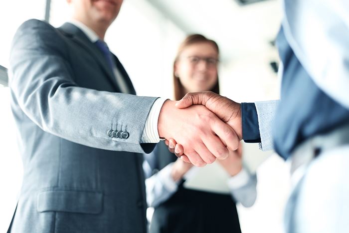 A man shaking the hand of another individual