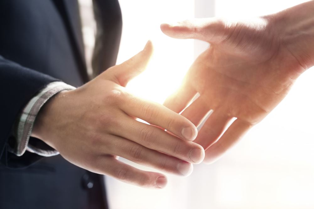 two men about to shake hands